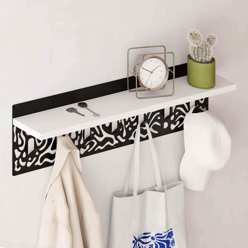 DIZZY Wall Hanger in white and black, featuring seven metal hangers and a sleek design, perfect for home or office organization.