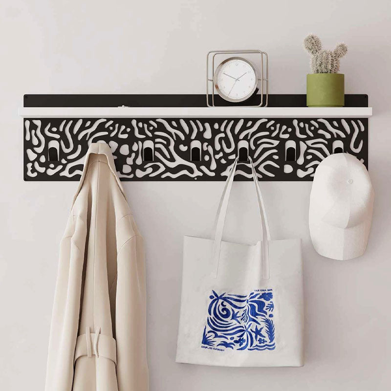 DIZZY Wall Hanger in white and black, featuring seven metal hangers and a sleek design, perfect for home or office organization.