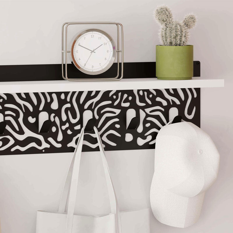 DIZZY Wall Hanger in white and black, featuring seven metal hangers and a sleek design, perfect for home or office organization.