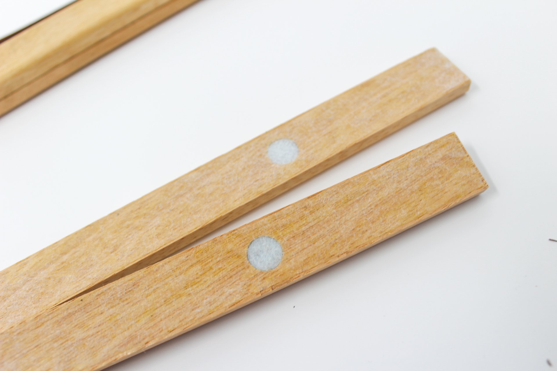 Wanderframe Magnetic Hanging Frame displaying a Scratch Your Travel Map, featuring teak wood and vegan leather string.