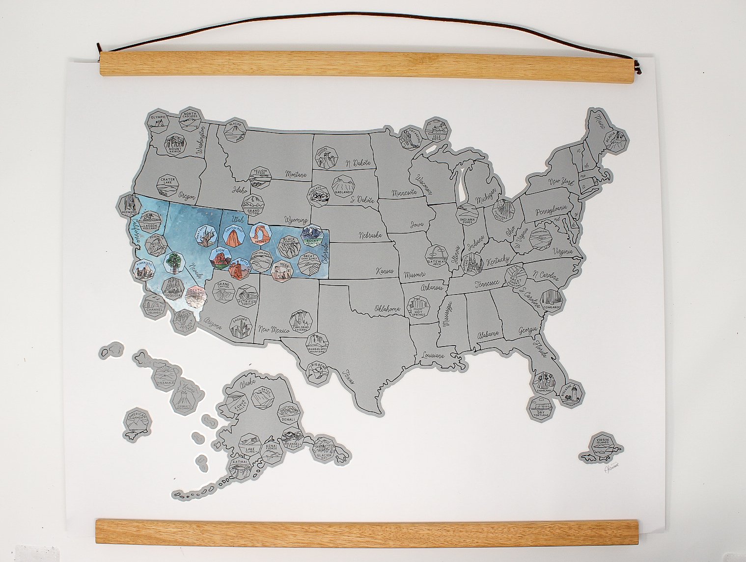 Wanderframe Magnetic Hanging Frame displaying a Scratch Your Travel Map, featuring teak wood and vegan leather string.
