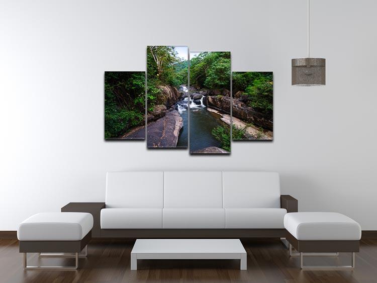 A beautiful 4-panel canvas artwork depicting a serene waterfall in a lush forest, showcasing vibrant colors and intricate details.