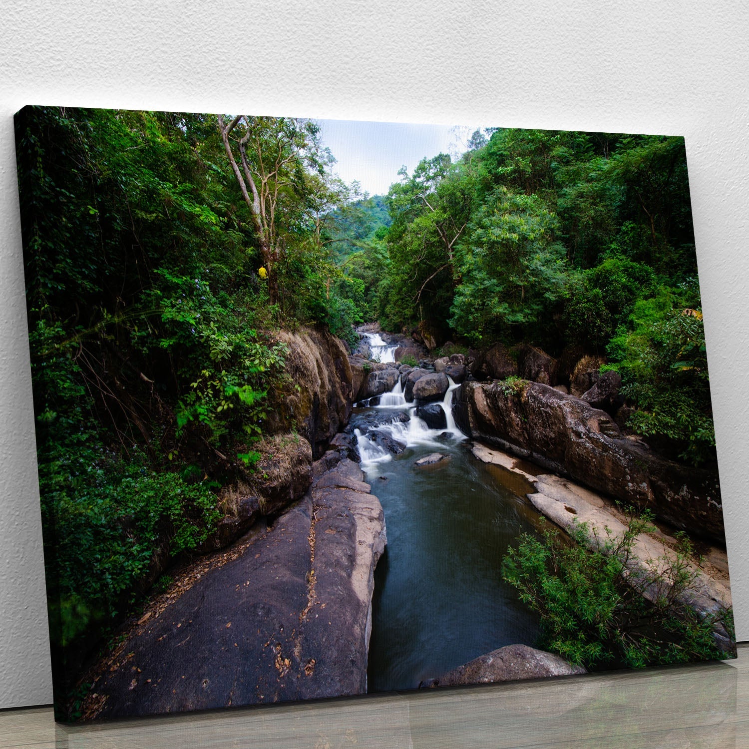 A beautiful canvas print of a waterfall in a lush forest, showcasing vibrant colors and serene nature.