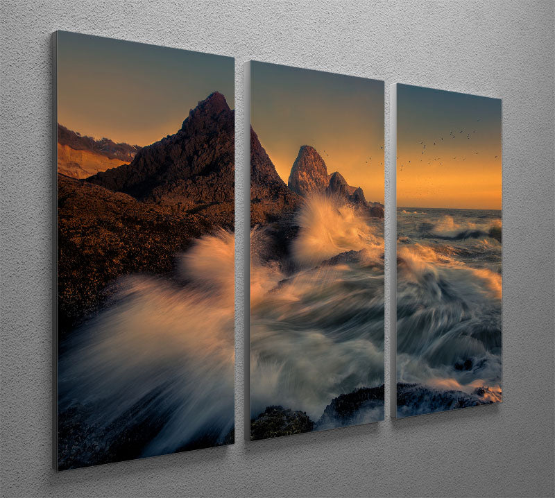A stunning 3-panel canvas print depicting waves crashing against a cliff, showcasing vibrant colors and dynamic movement.