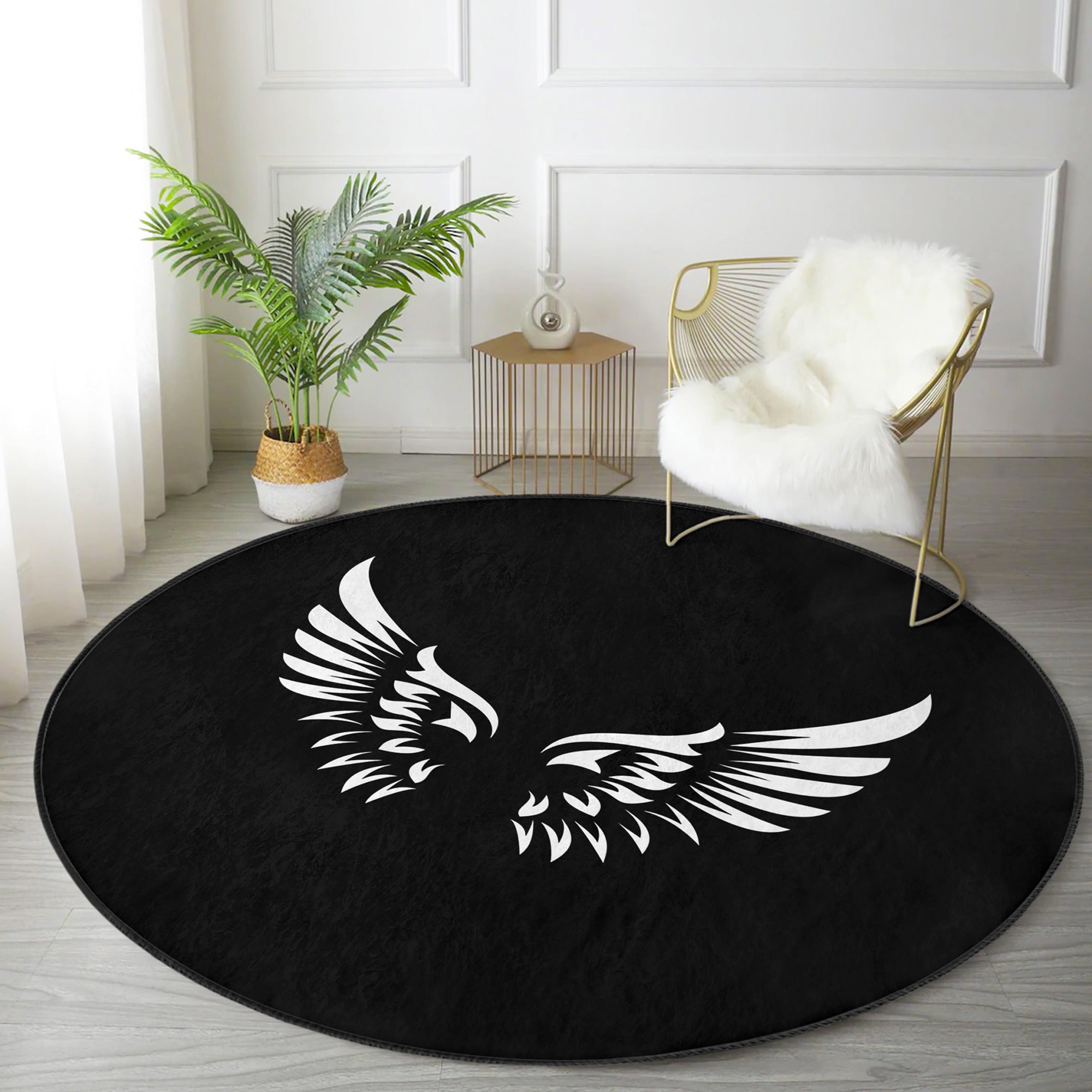 A round rug featuring white angel wings design on a black background, showcasing its soft velvet texture and elegant appearance.