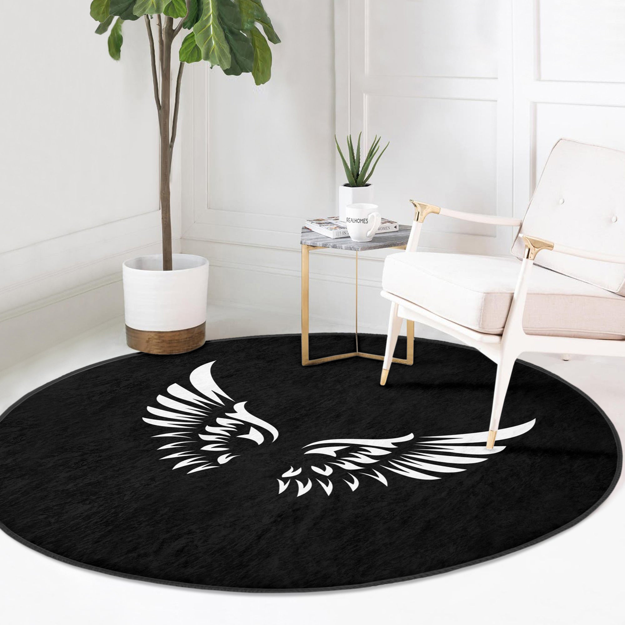 A round rug featuring white angel wings design on a black background, showcasing its soft velvet texture and elegant appearance.