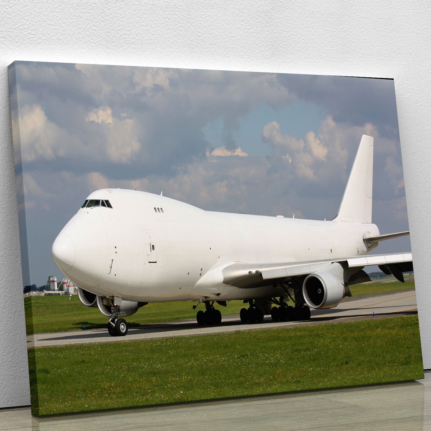 A stunning canvas print of a white cargo plane taxiing on a runway, showcasing its sleek design and vibrant colors.