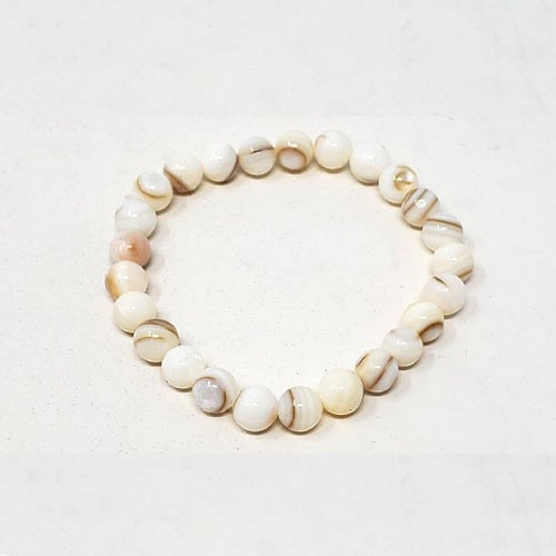 Elegant white mother of pearl bracelet, perfect for Mother's Day gift, showcasing its iridescent sheen and handcrafted design.