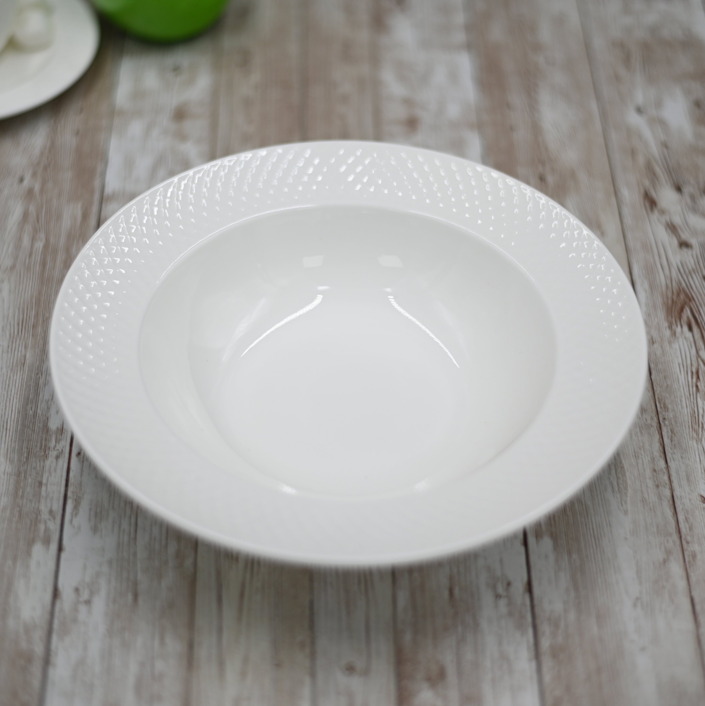 Set of six white porcelain deep plates with embossed wide rim, perfect for serving soups and elegant dining.