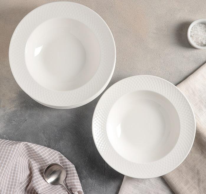 Set of six white porcelain deep plates with embossed wide rim, perfect for serving soups and elegant dining.