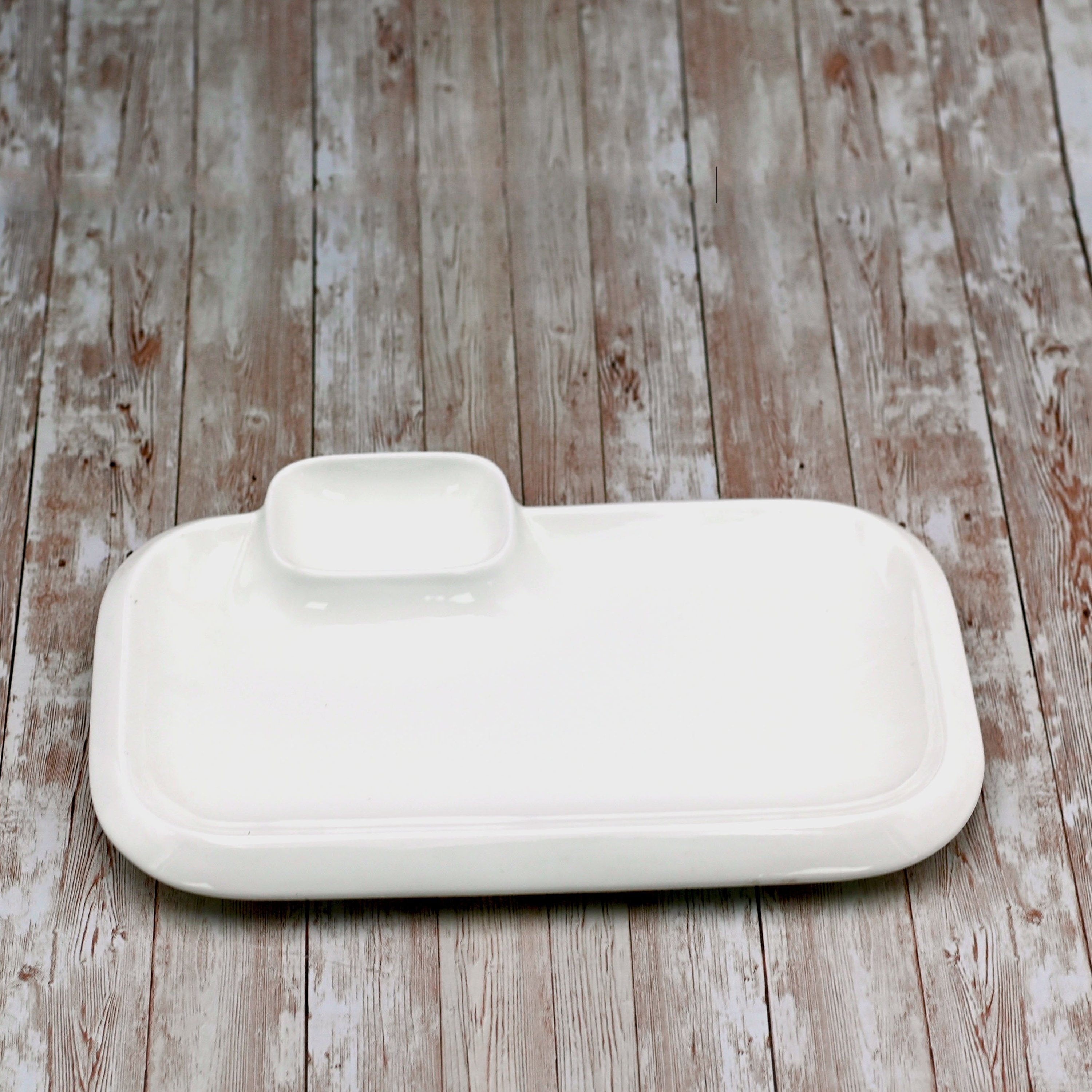 Elegant white rectangular platter with sauce compartment, perfect for serving various dishes.