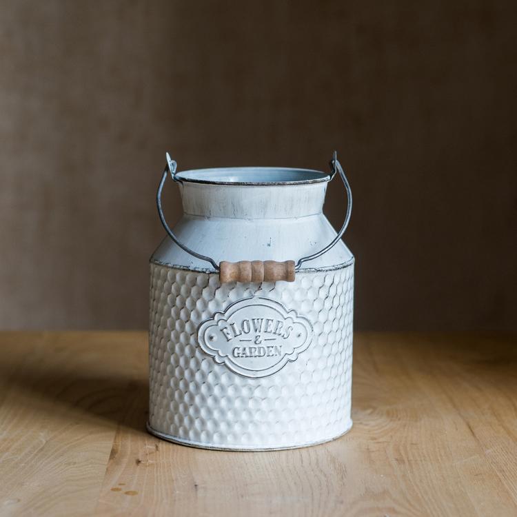 A charming white small iron flower garden barrel with a decorative design, perfect for planting flowers or small plants.