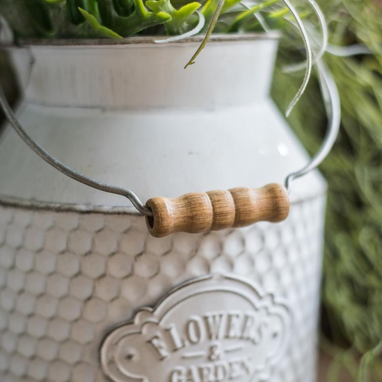 A charming white small iron flower garden barrel with a decorative design, perfect for planting flowers or small plants.