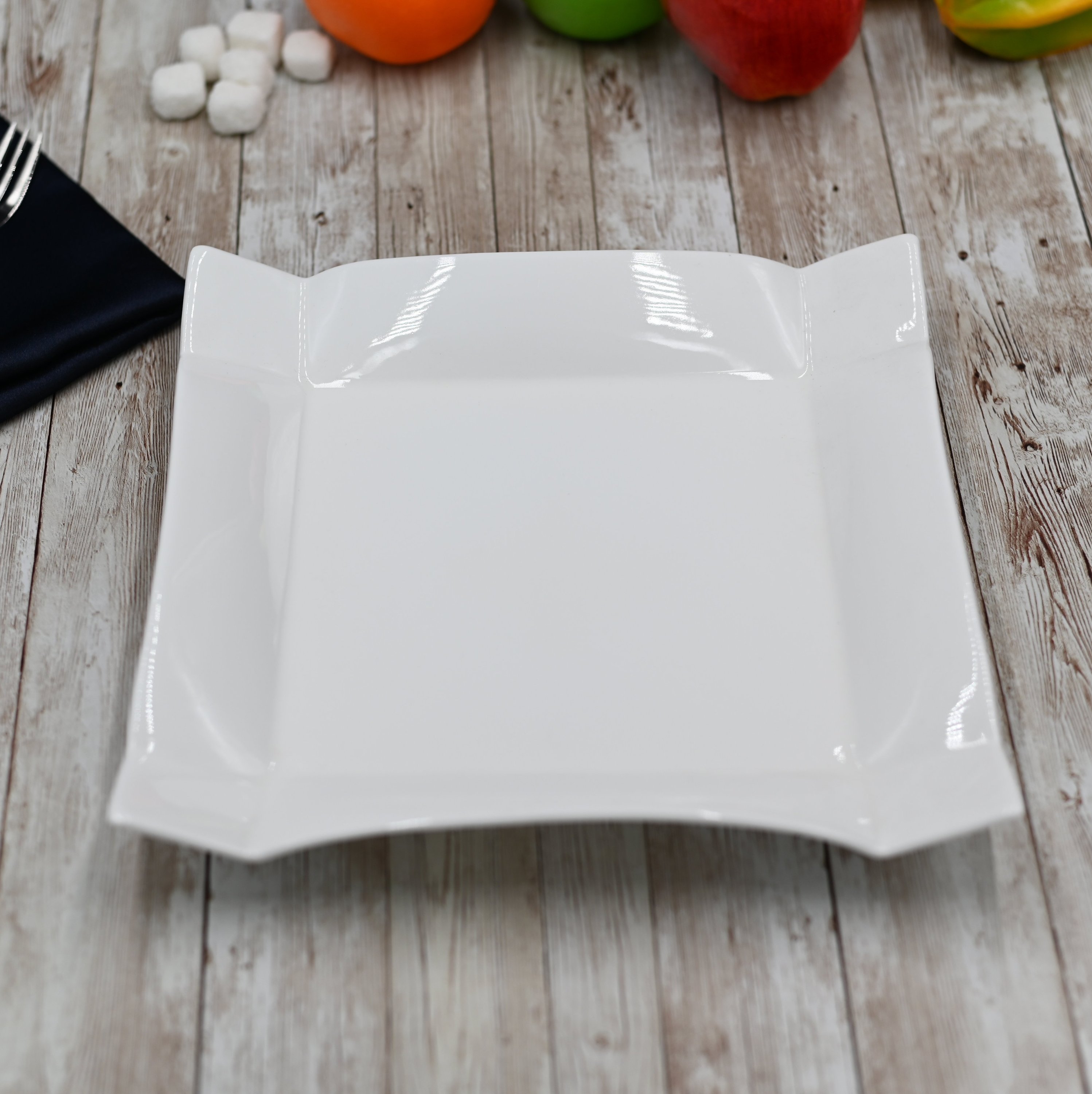 A pristine white square dinner plate measuring 10 inches by 10 inches, showcasing its elegant design and smooth finish.