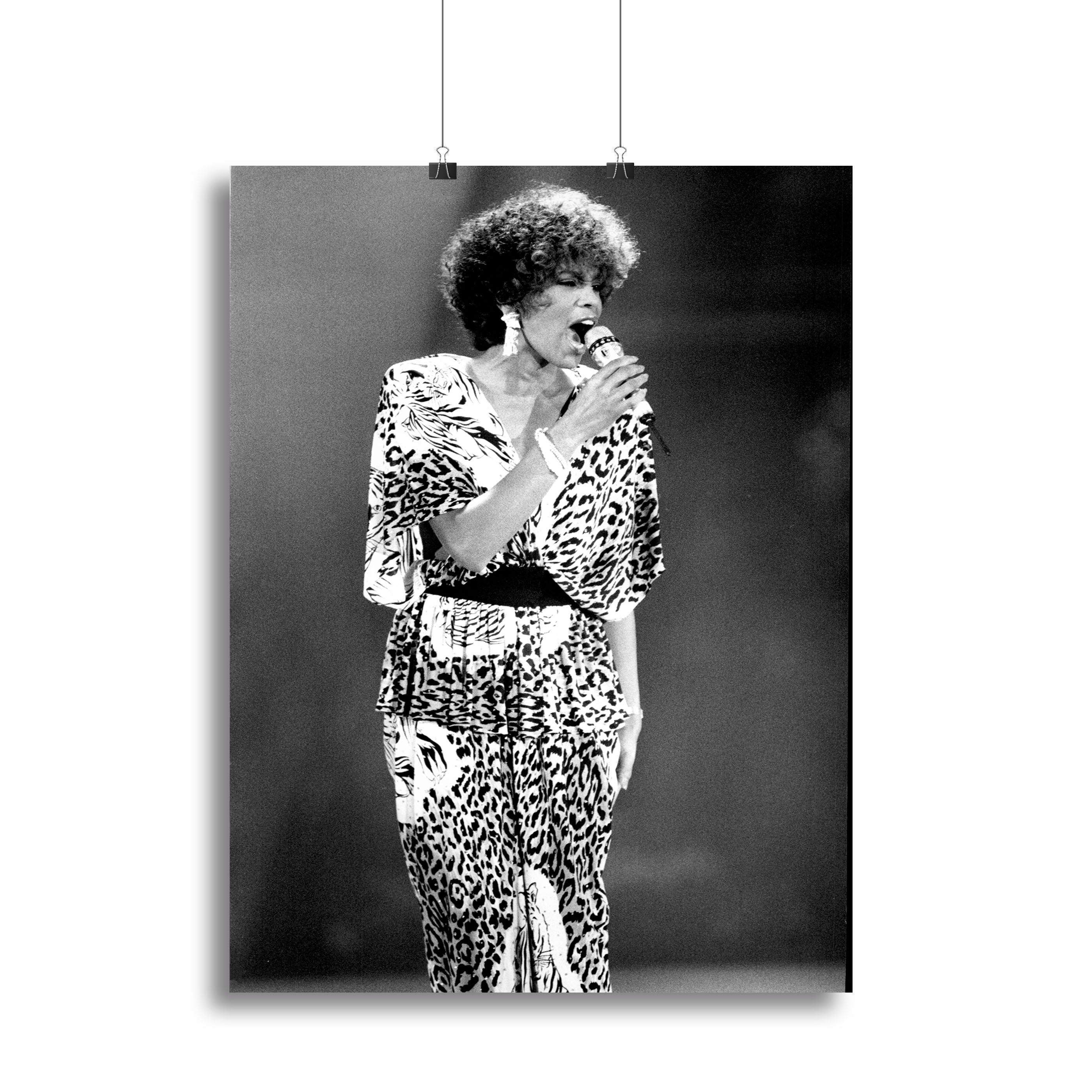 A vibrant canvas print or poster featuring Whitney Houston performing on stage, showcasing her iconic presence and energy.