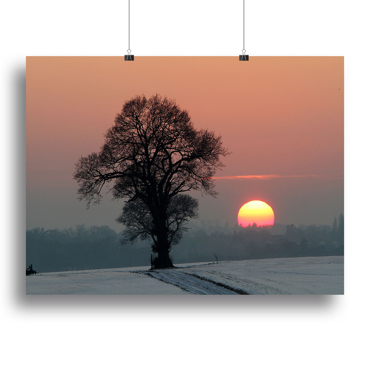A beautiful Winter Sunset Canvas Print featuring vibrant colors of a sunset over a snowy landscape, perfect for home decor.