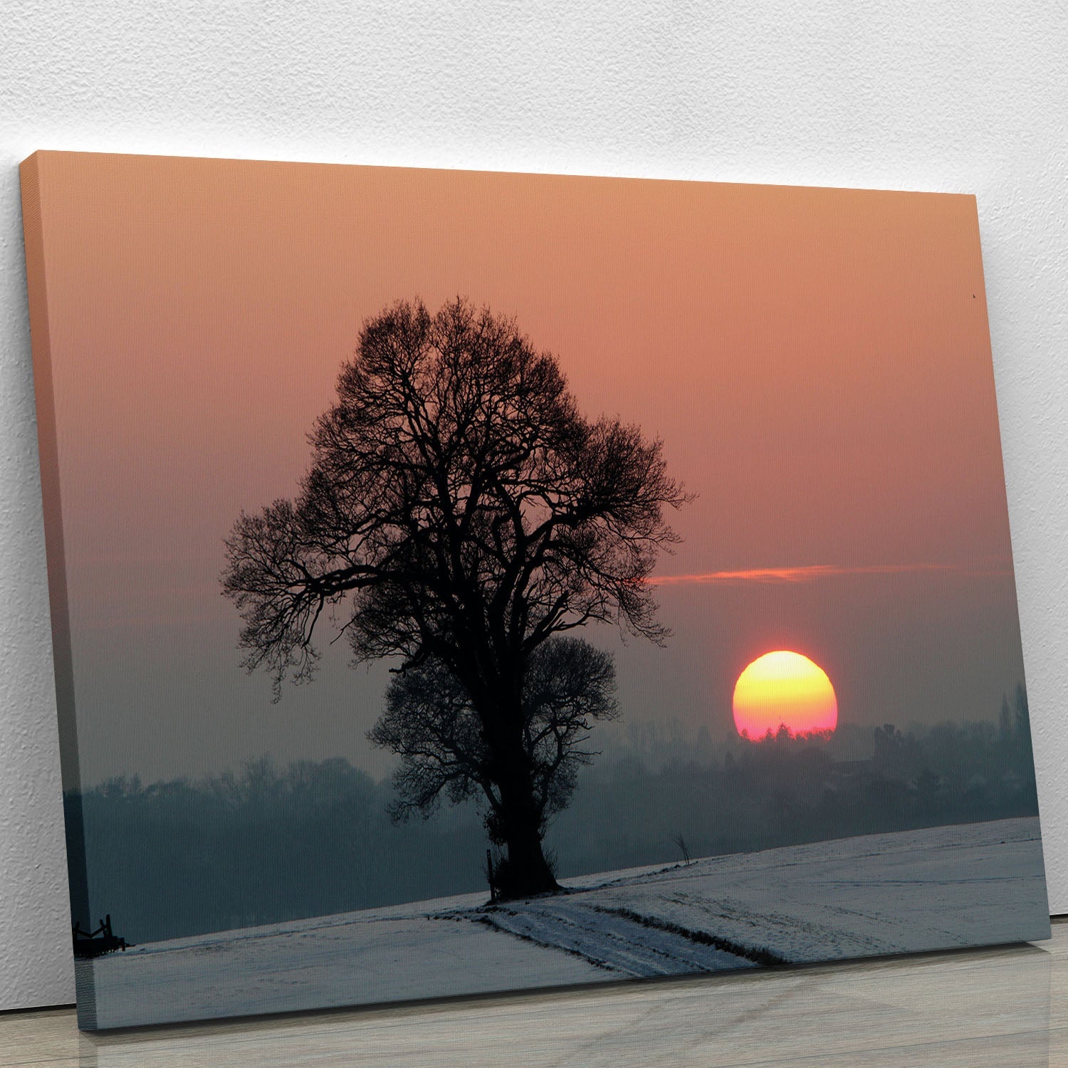 A beautiful Winter Sunset Canvas Print featuring vibrant colors of a sunset over a snowy landscape, perfect for home decor.