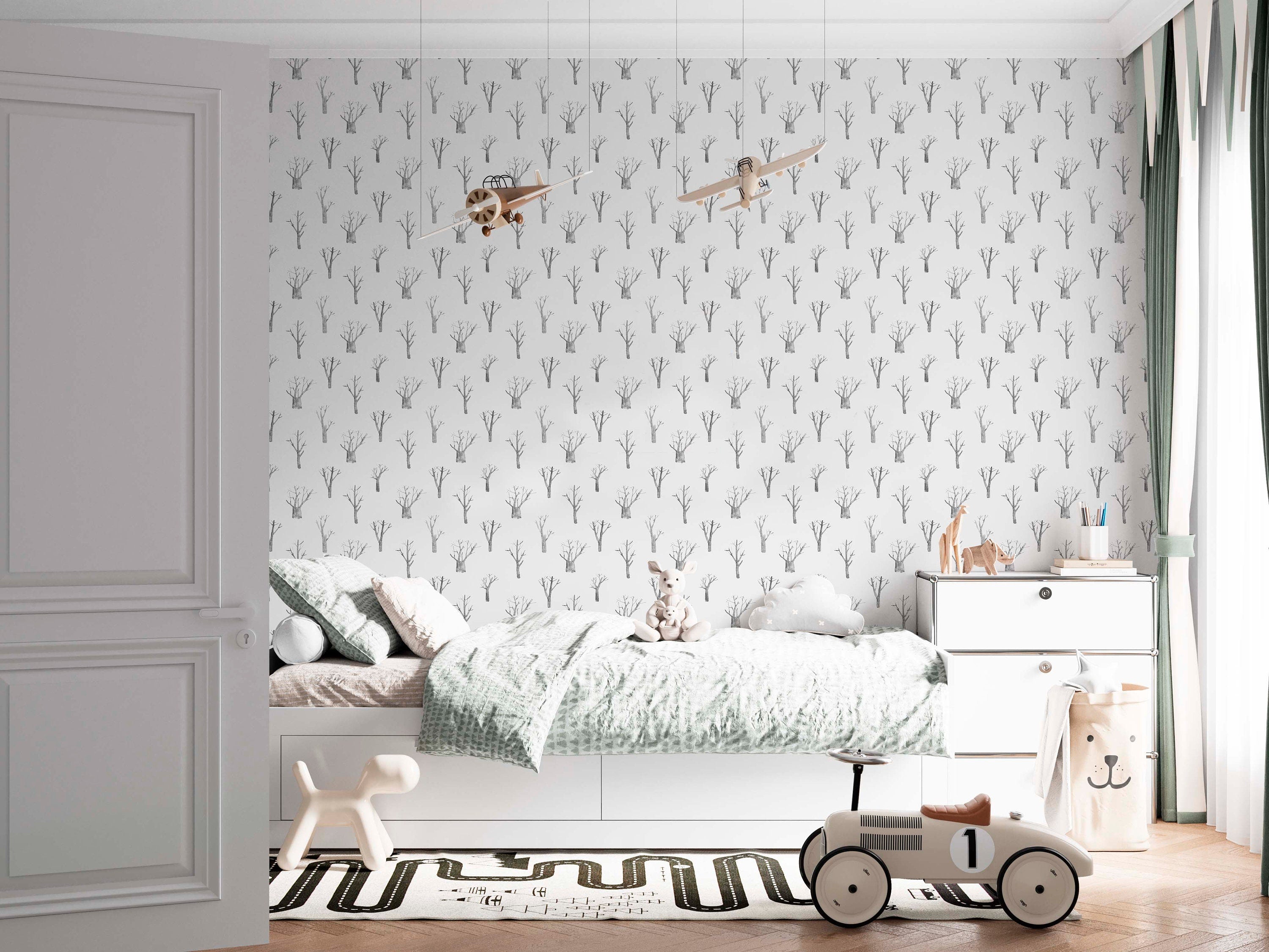 Elegant winter trees wallpaper in soothing white and grey tones, perfect for nursery bedrooms.