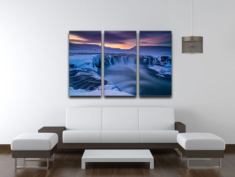 A beautiful 3-panel canvas print featuring a serene wintry waterfall scene, perfect for home decor.