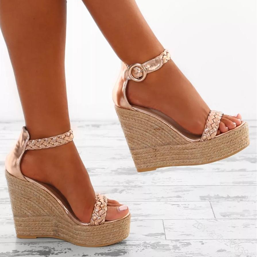 Stylish women's gold wedge sandals with open toe design, featuring a buckle strap and straw outsole, perfect for casual occasions.