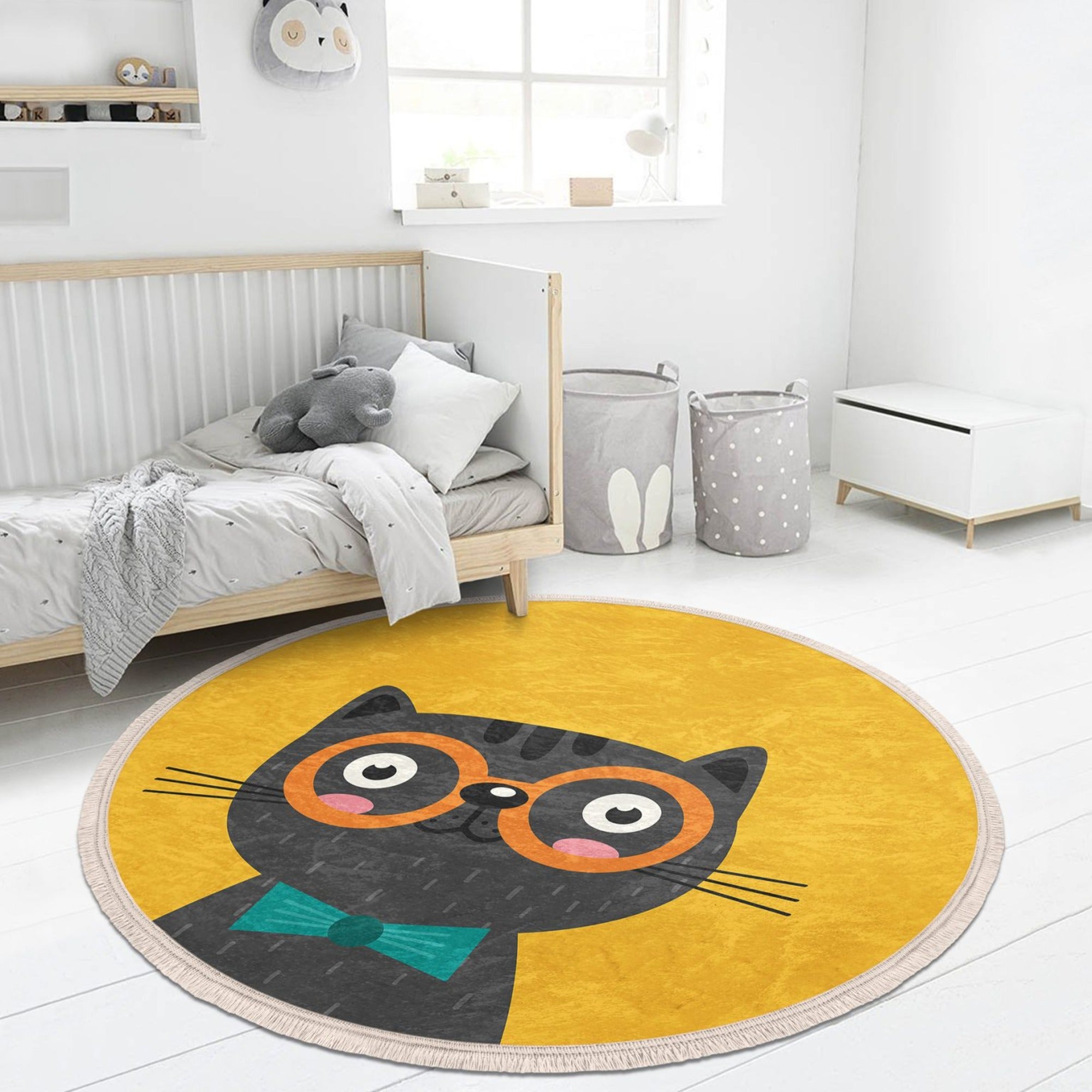 A vibrant yellow round rug featuring playful cat patterns, perfect for kids' rooms and nurseries.
