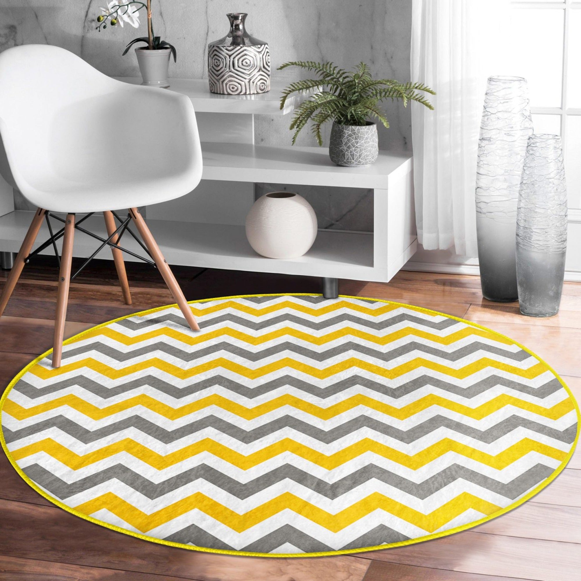 A beautifully designed yellow, gray, and white patterned round rug, showcasing its soft velvet texture and modern aesthetic.