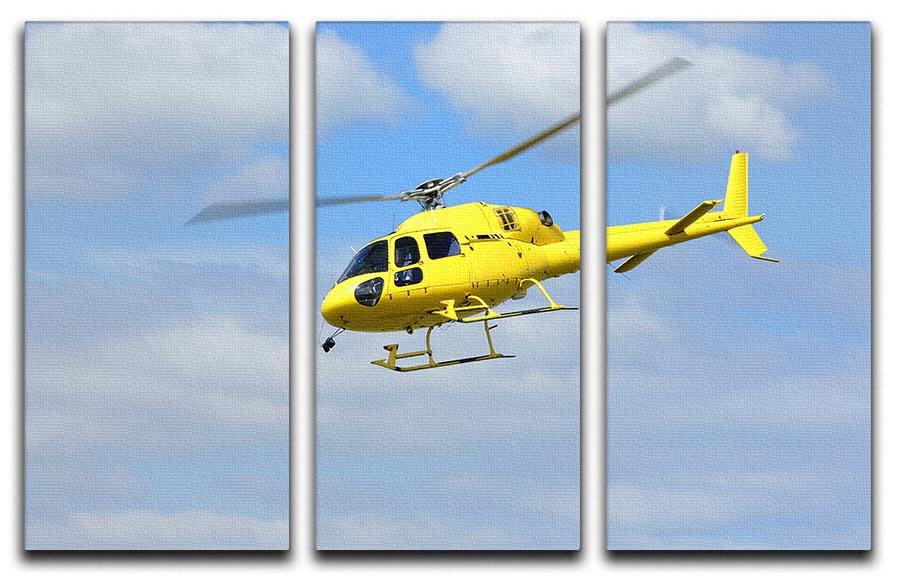 A vibrant yellow helicopter soaring in the air, depicted in a stunning 3-panel canvas print, perfect for home or office decor.
