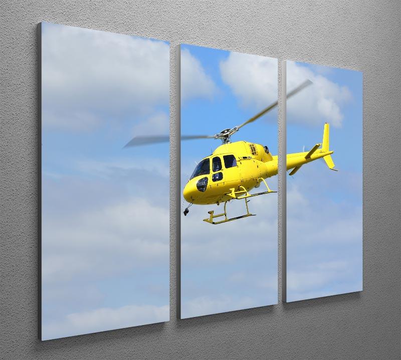 A vibrant yellow helicopter soaring in the air, depicted in a stunning 3-panel canvas print, perfect for home or office decor.