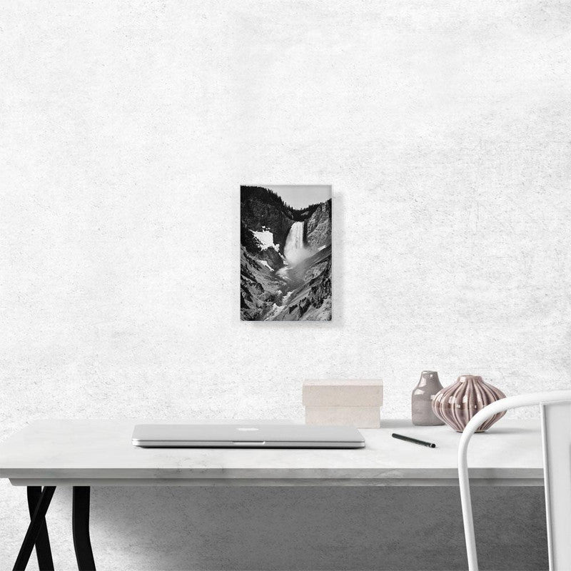 A stunning canvas print of Yellowstone Falls, showcasing the majestic waterfall surrounded by lush greenery and vibrant blue skies.