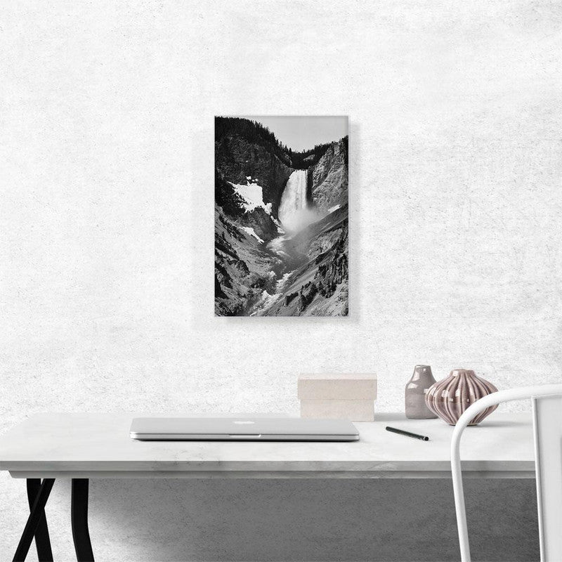 A stunning canvas print of Yellowstone Falls, showcasing the majestic waterfall surrounded by lush greenery and vibrant blue skies.