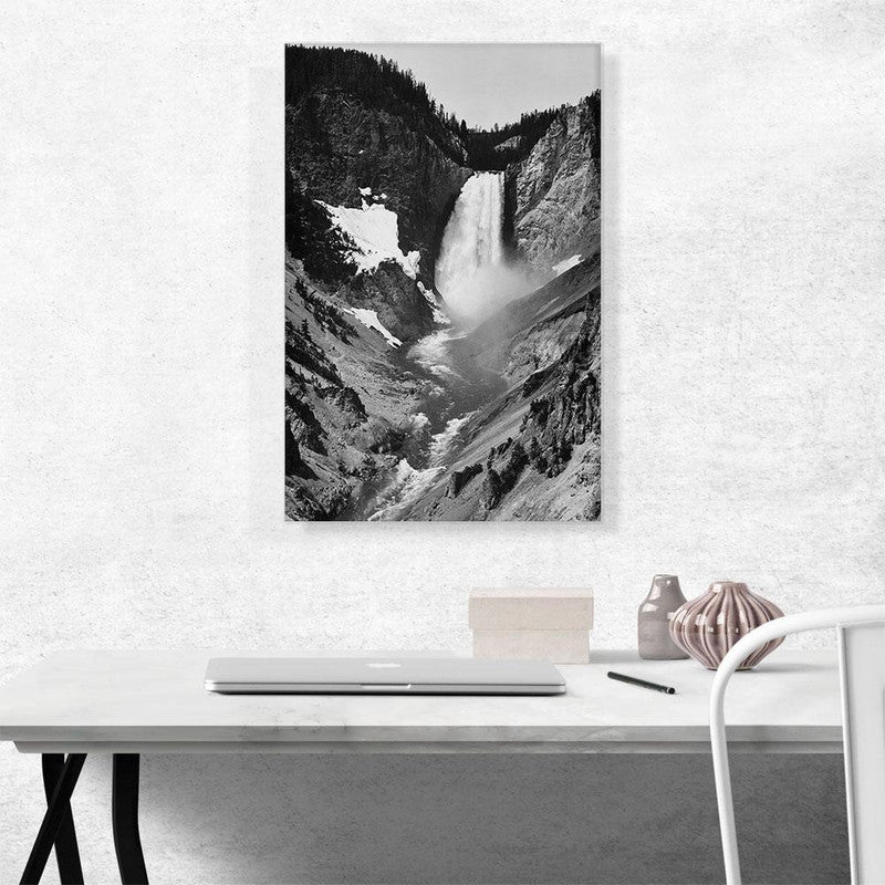 A stunning canvas print of Yellowstone Falls, showcasing the majestic waterfall surrounded by lush greenery and vibrant blue skies.