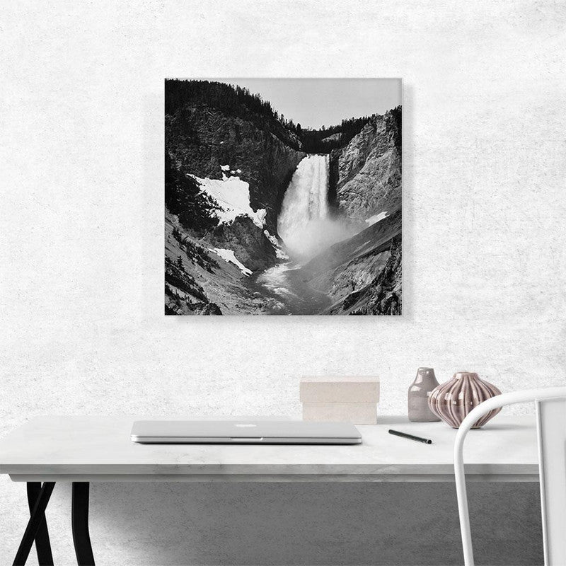 A stunning canvas print of Yellowstone Falls in Wyoming, showcasing the vibrant colors and majestic beauty of the waterfall surrounded by lush greenery.