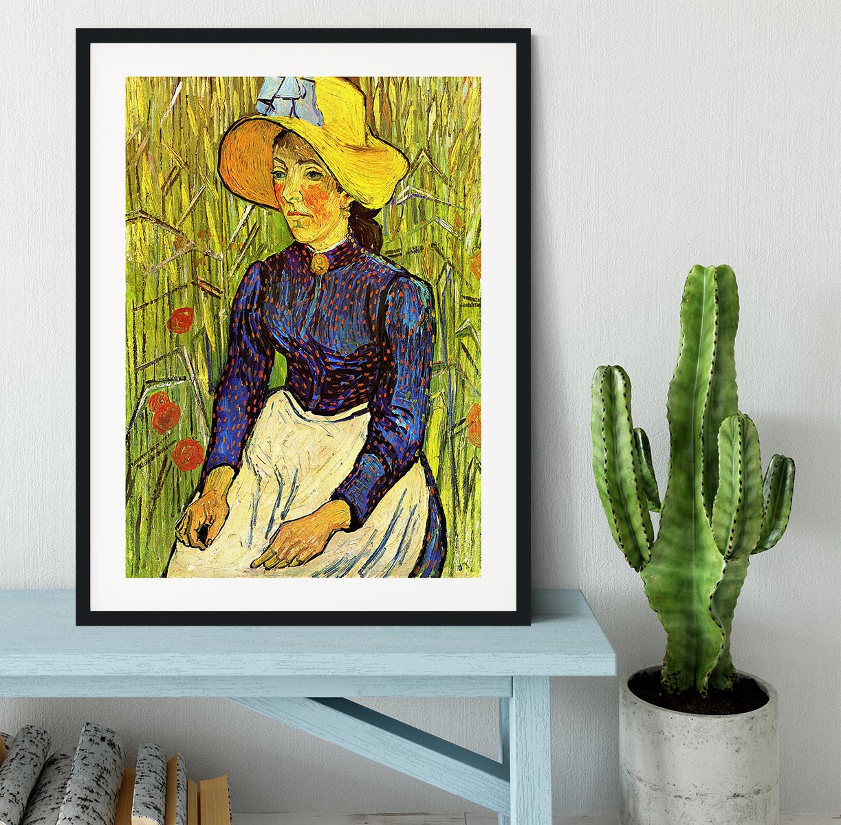 A beautifully framed reproduction of Van Gogh's Young Peasant Woman with Straw Hat Sitting in the Wheat, showcasing vibrant colors and quality craftsmanship.
