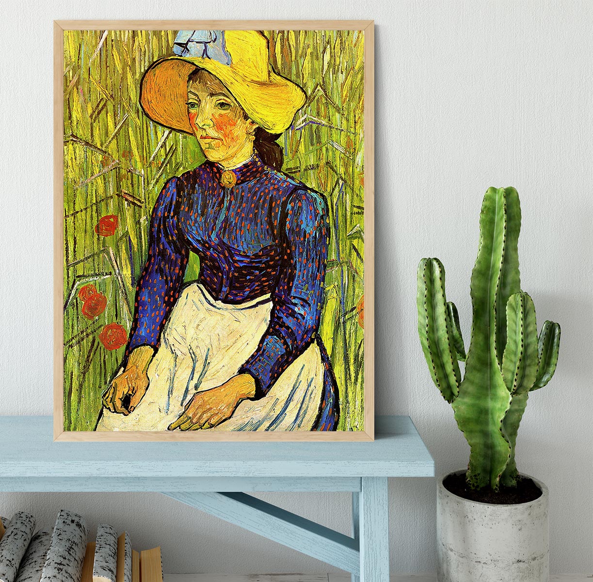 A beautifully framed reproduction of Van Gogh's Young Peasant Woman with Straw Hat Sitting in the Wheat, showcasing vibrant colors and quality craftsmanship.