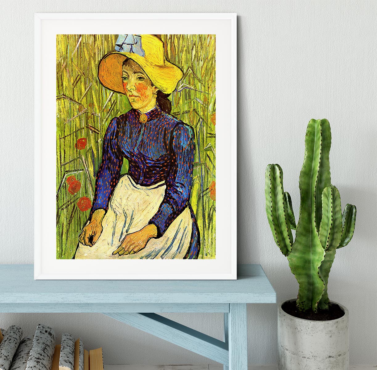 A beautifully framed reproduction of Van Gogh's Young Peasant Woman with Straw Hat Sitting in the Wheat, showcasing vibrant colors and quality craftsmanship.
