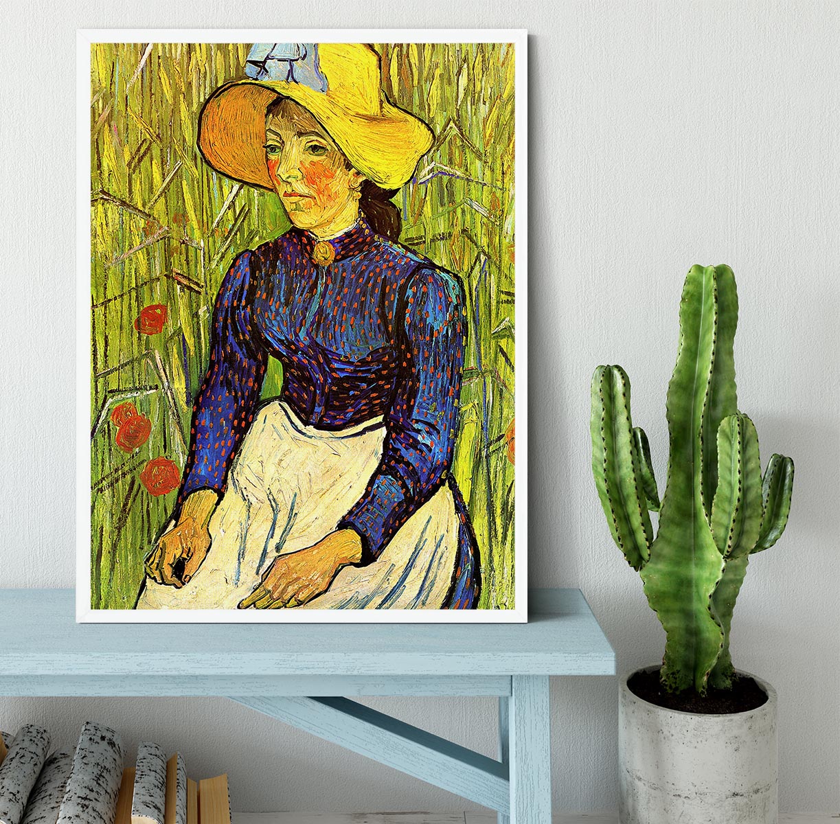 A beautifully framed reproduction of Van Gogh's Young Peasant Woman with Straw Hat Sitting in the Wheat, showcasing vibrant colors and quality craftsmanship.