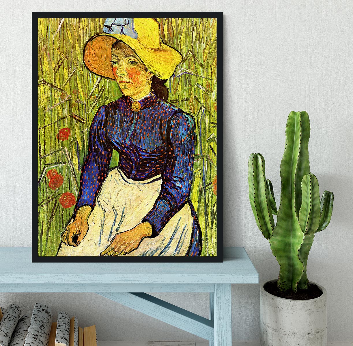 A beautifully framed reproduction of Van Gogh's Young Peasant Woman with Straw Hat Sitting in the Wheat, showcasing vibrant colors and quality craftsmanship.