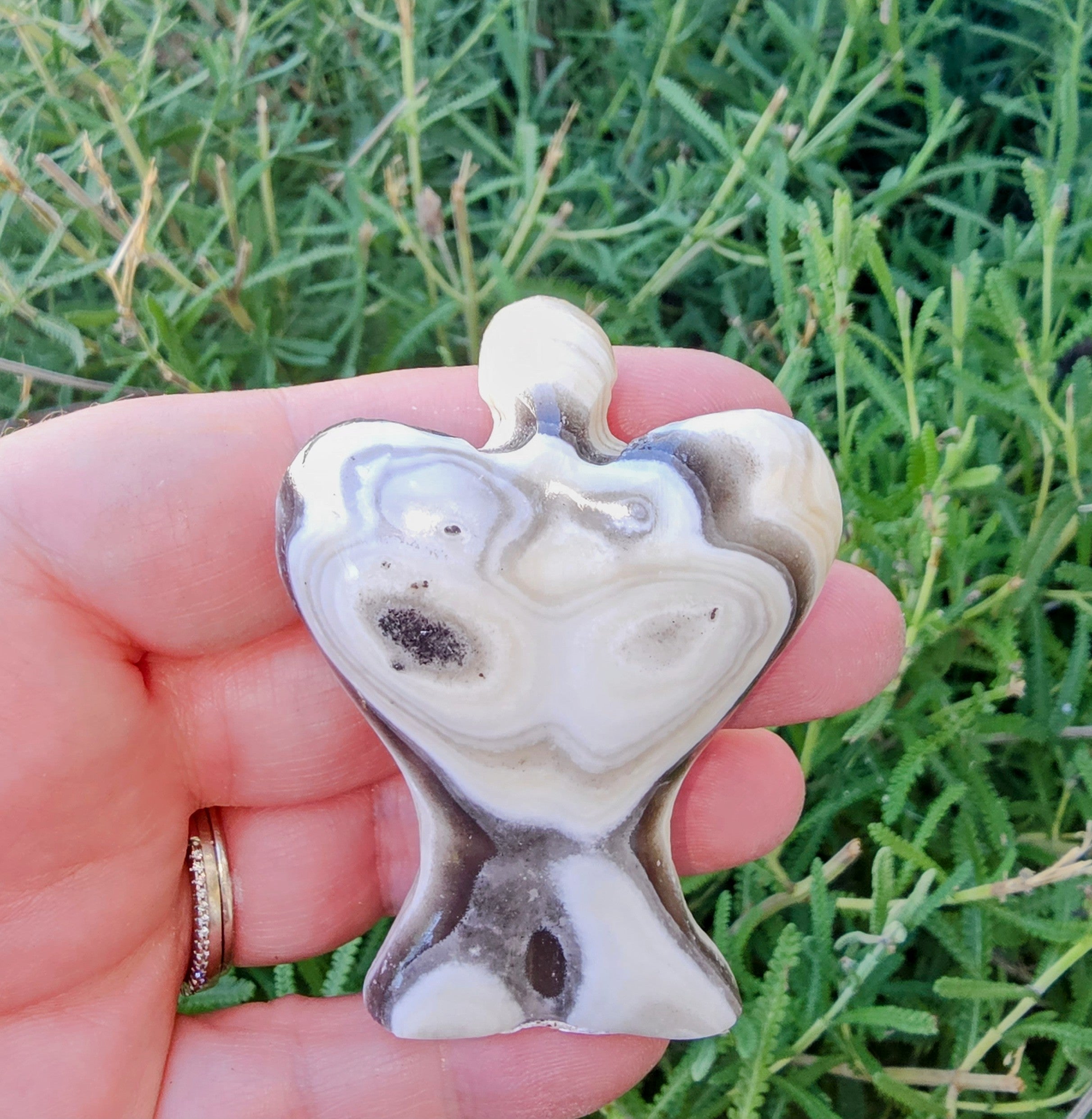 Hand-carved Zebra Onyx Angel sculpture showcasing yellow, gray, white, and black bands.