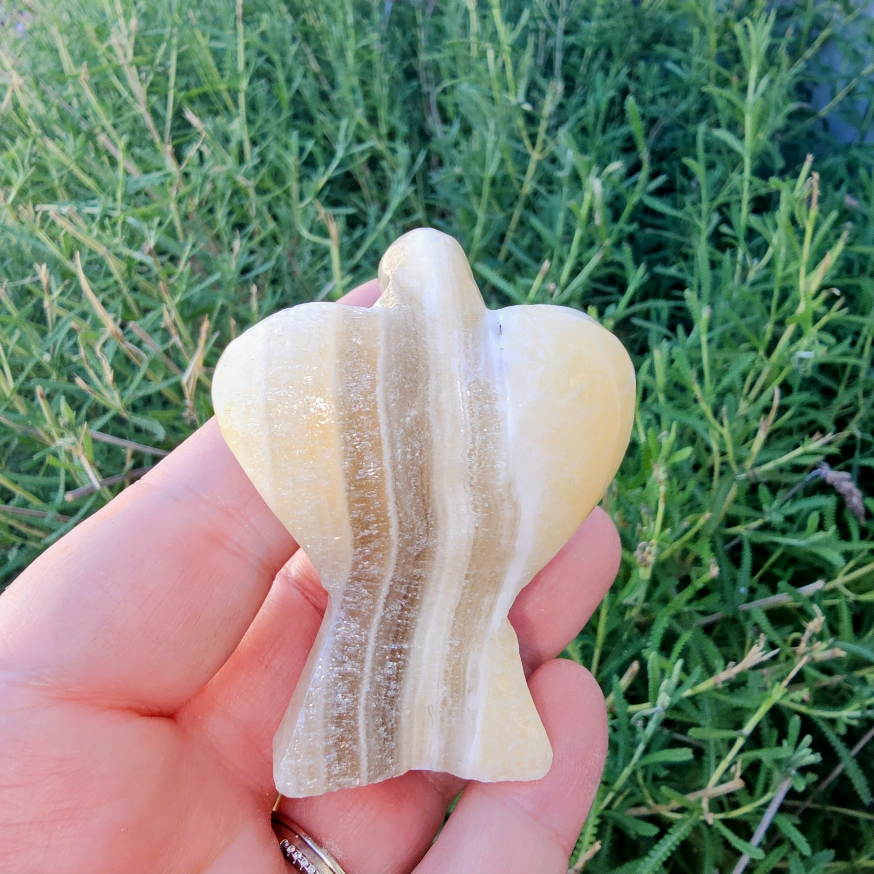 Hand-carved Zebra Onyx Angel sculpture showcasing yellow, gray, white, and black bands.