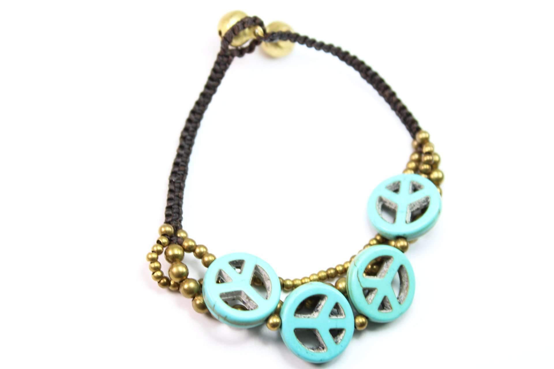 Handmade Boho Peace Symbol Bracelet featuring bone charms, antique brass beads, and a black rope design with jingle bells closure.