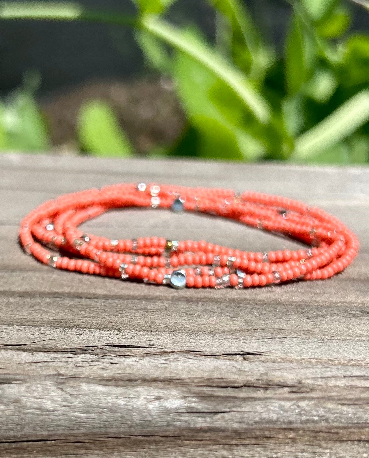 Coral pink and silver sprinkle beaded 5-wrap boho bracelet made from Czech glass seed beads on elastic cording.