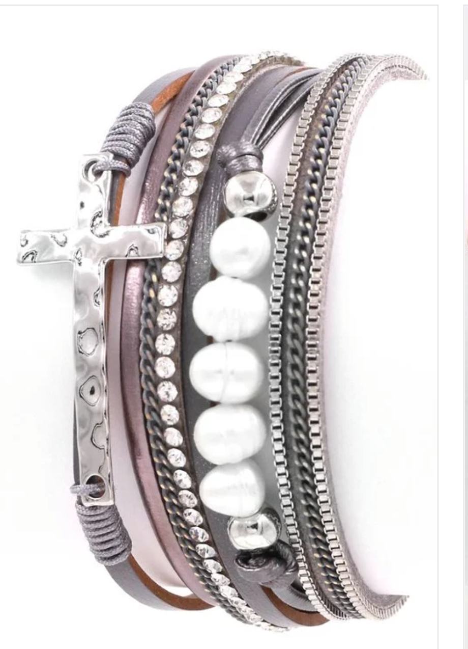 Elegant cross and pearl multi-layer magnetic bracelet with adjustable closure.