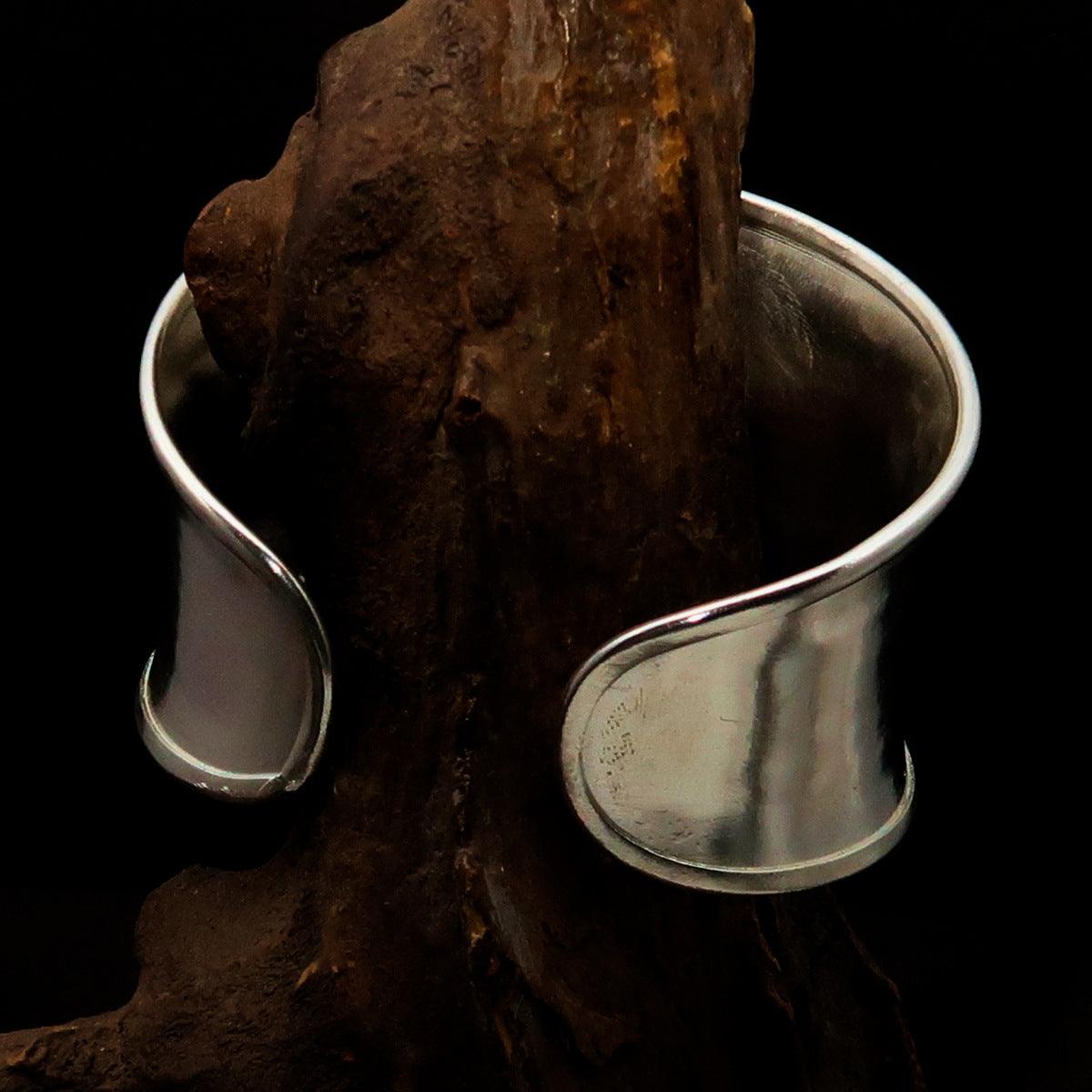 A beautifully handcrafted extra wide sterling silver bracelet, hallmarked 925, showcasing its elegant design and comfortable fit.