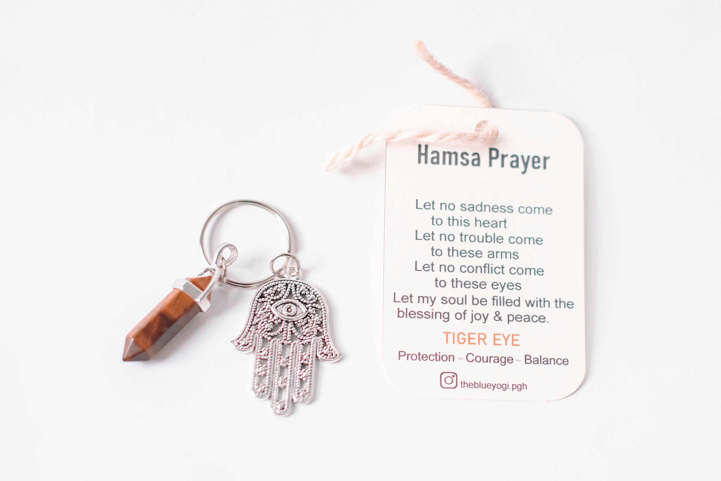 Hamsa & Tiger Eye Key Chain featuring a detailed Hamsa hand and a Tiger Eye stone, accompanied by a Hamsa Prayer Card.