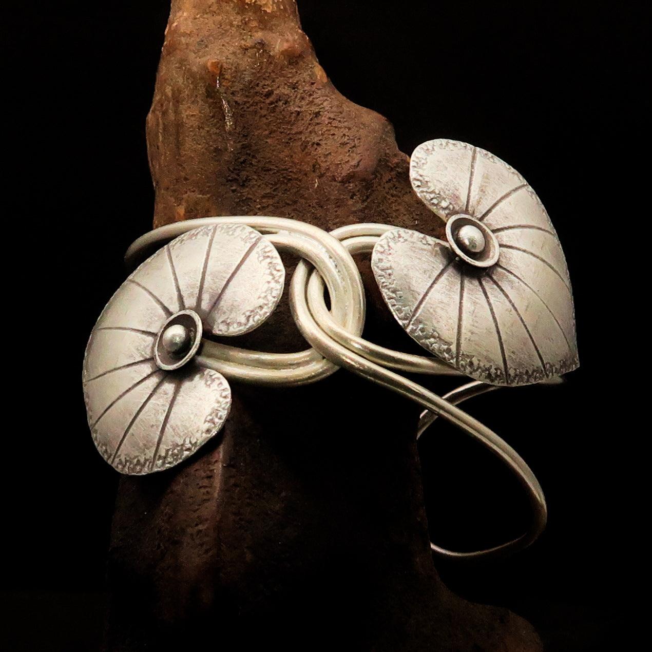 Lovely handcrafted sterling silver bracelet featuring two elegant leaf designs, showcasing intricate details and a comfortable fit.