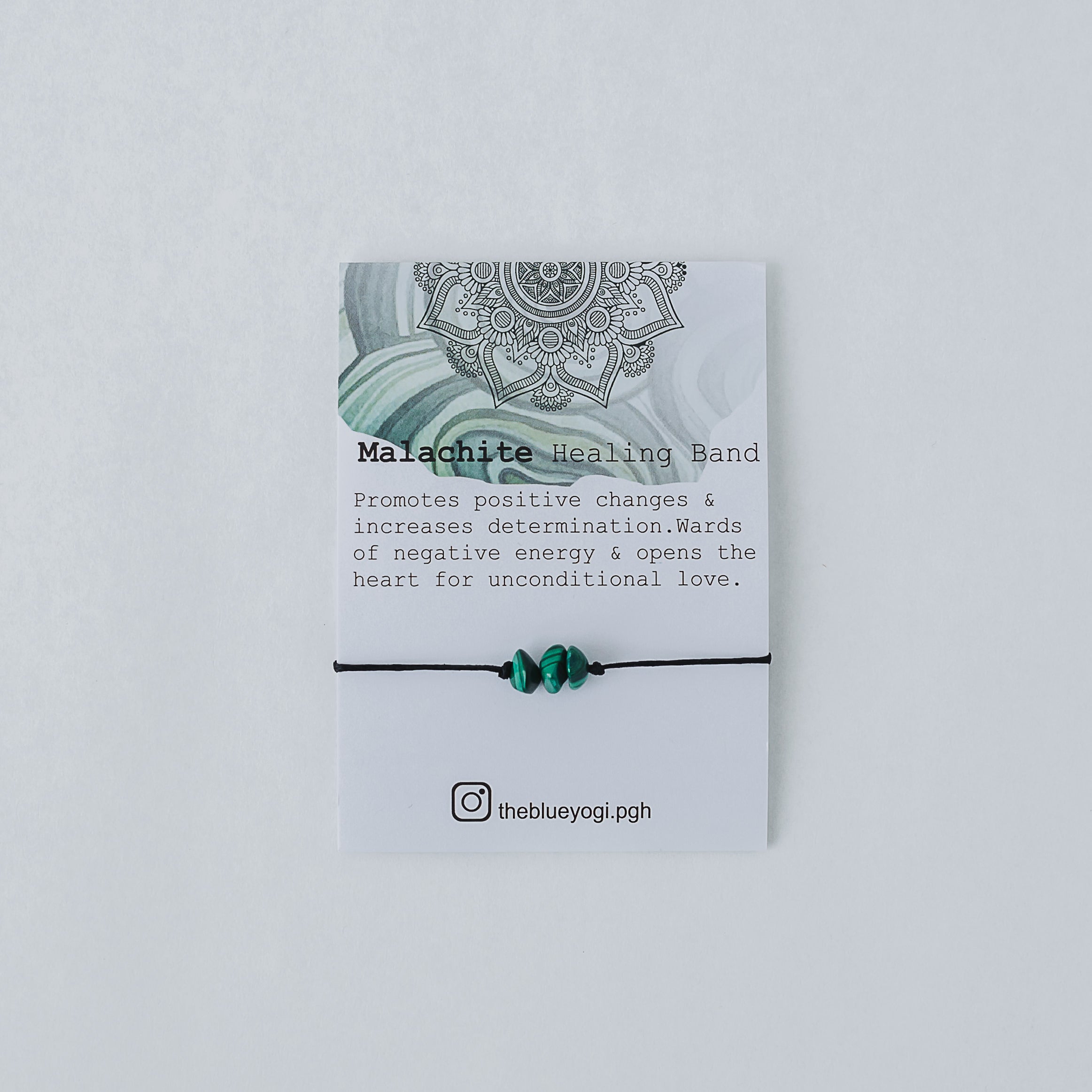 A handcrafted Malachite Healing Band featuring natural gemstones, designed for everyday wear with a tie closure, accompanied by a watercolor Mandala art card.