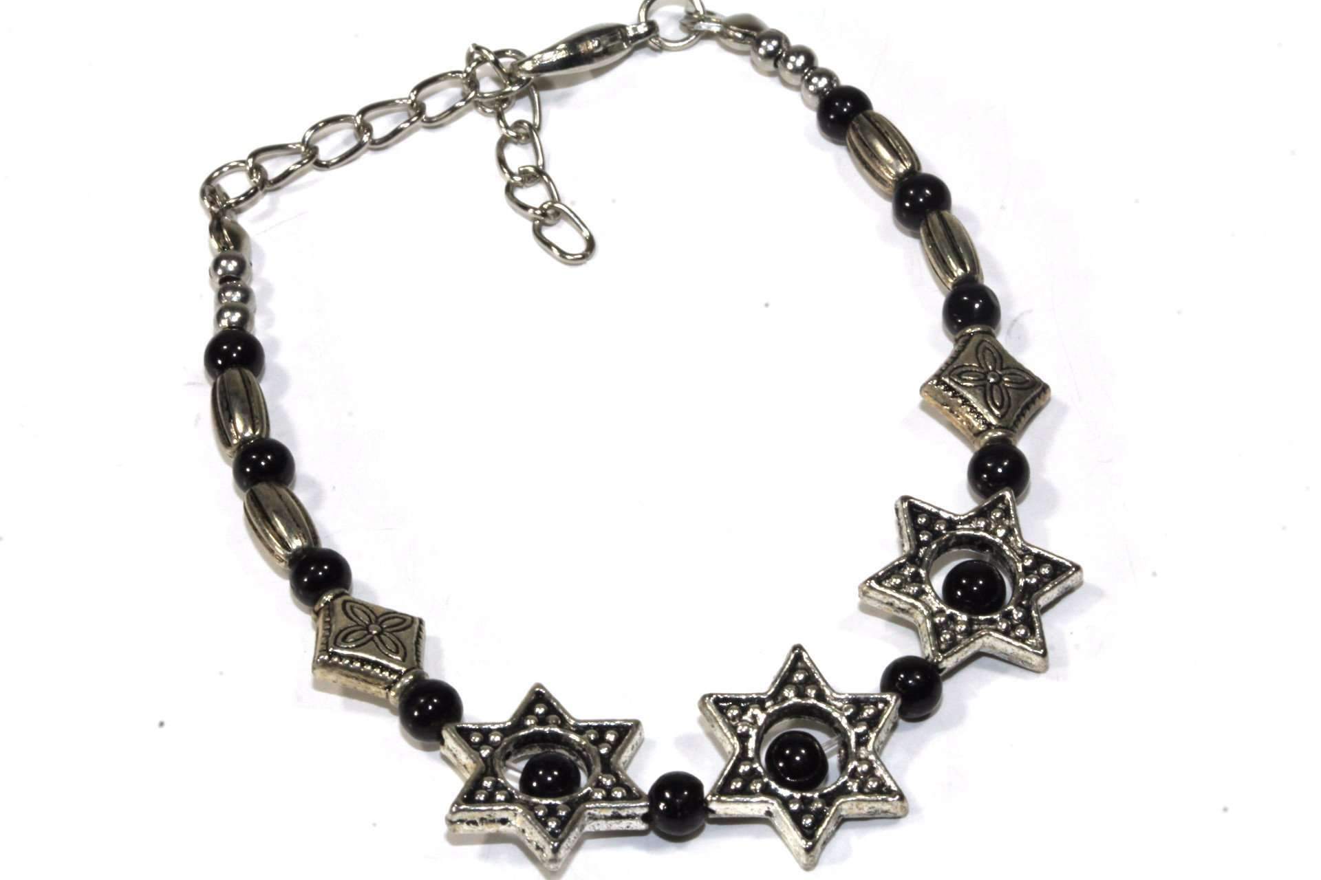 A stylish Mystical Star Bracelet featuring silver tone star and flower charms, shiny black beads, and a lobster clasp closure.