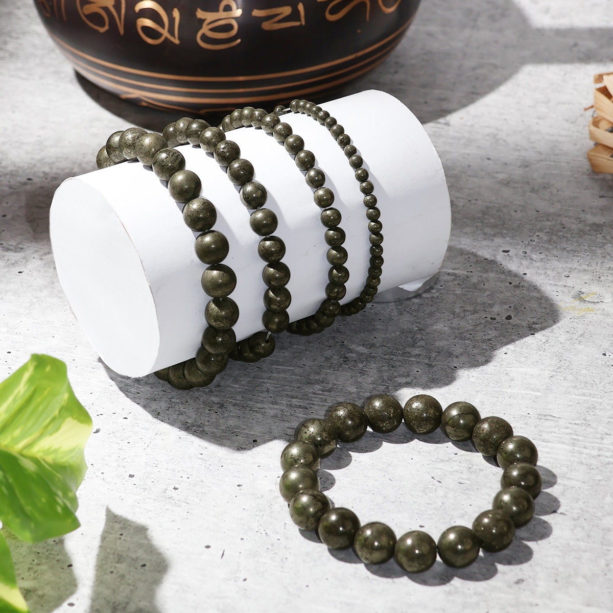 A stylish Pyrite Round Beads Bracelet featuring natural crystal beads, showcasing its unique shine and healing properties.
