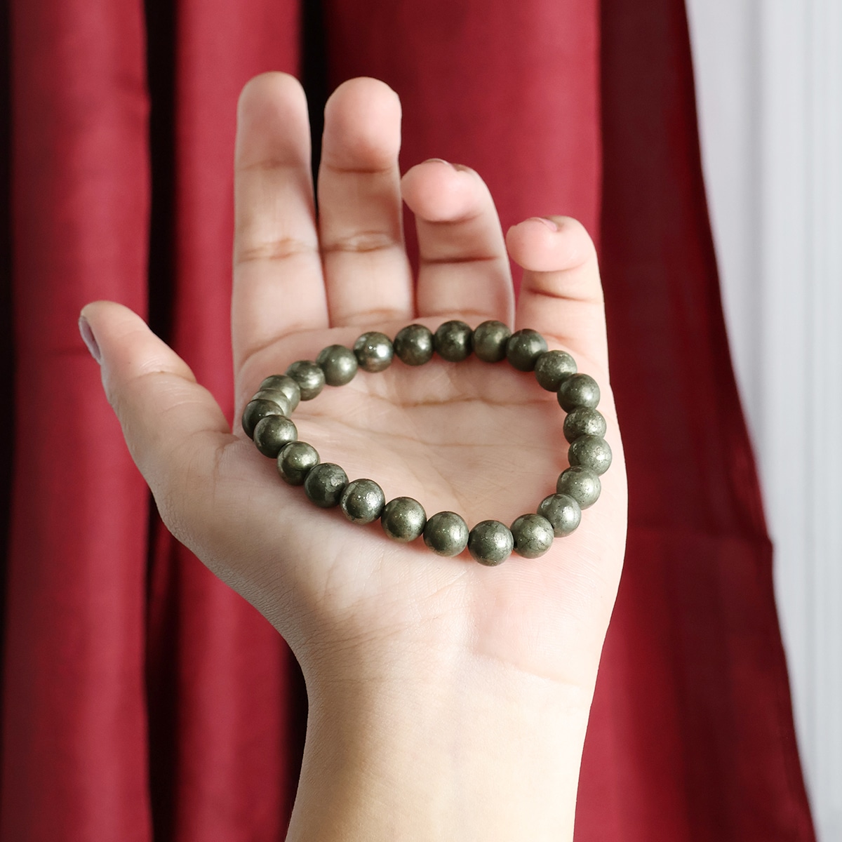 A stylish Pyrite Round Beads Bracelet showcasing natural crystals with a glossy finish, perfect for healing and fashion.