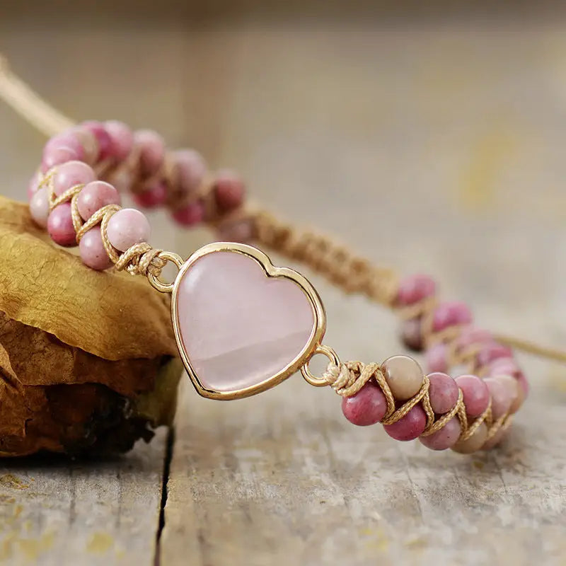A delicate Rose Quartz Heart Charm Bracelet featuring genuine gemstones in a heart-shaped design, perfect for love and healing.